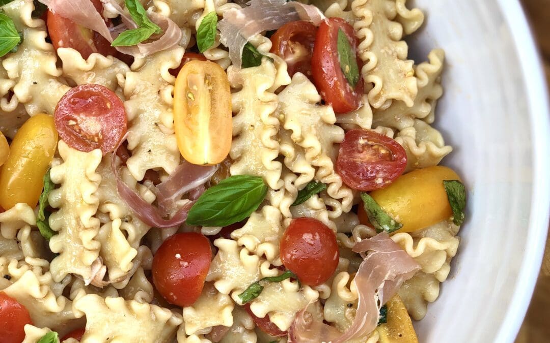 Summer fresh marinated tomato pasta salad with prosciutto
