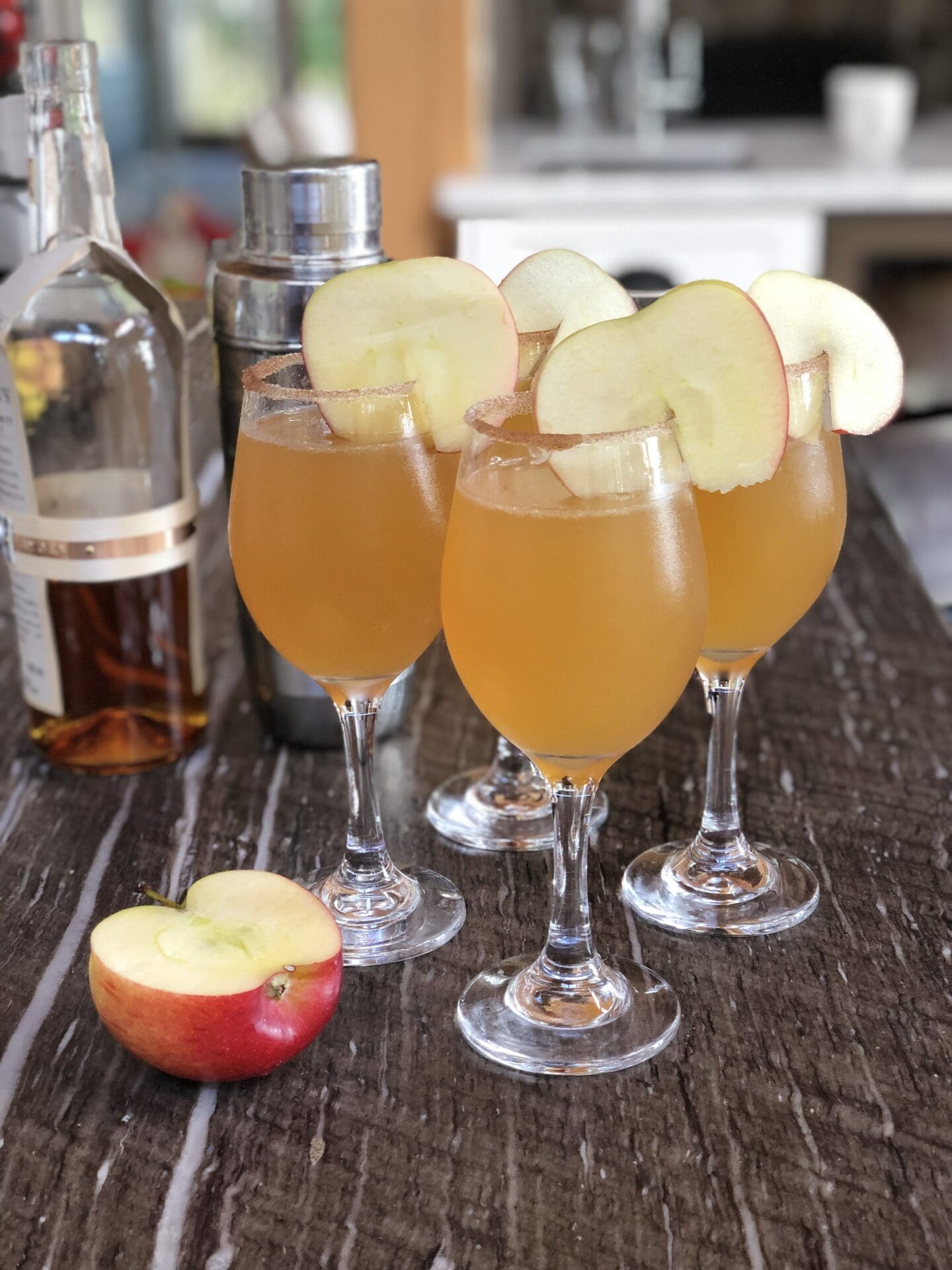 Bourbon Apple Cider Cocktails with cinnamon sugar rim and apple slice garnish