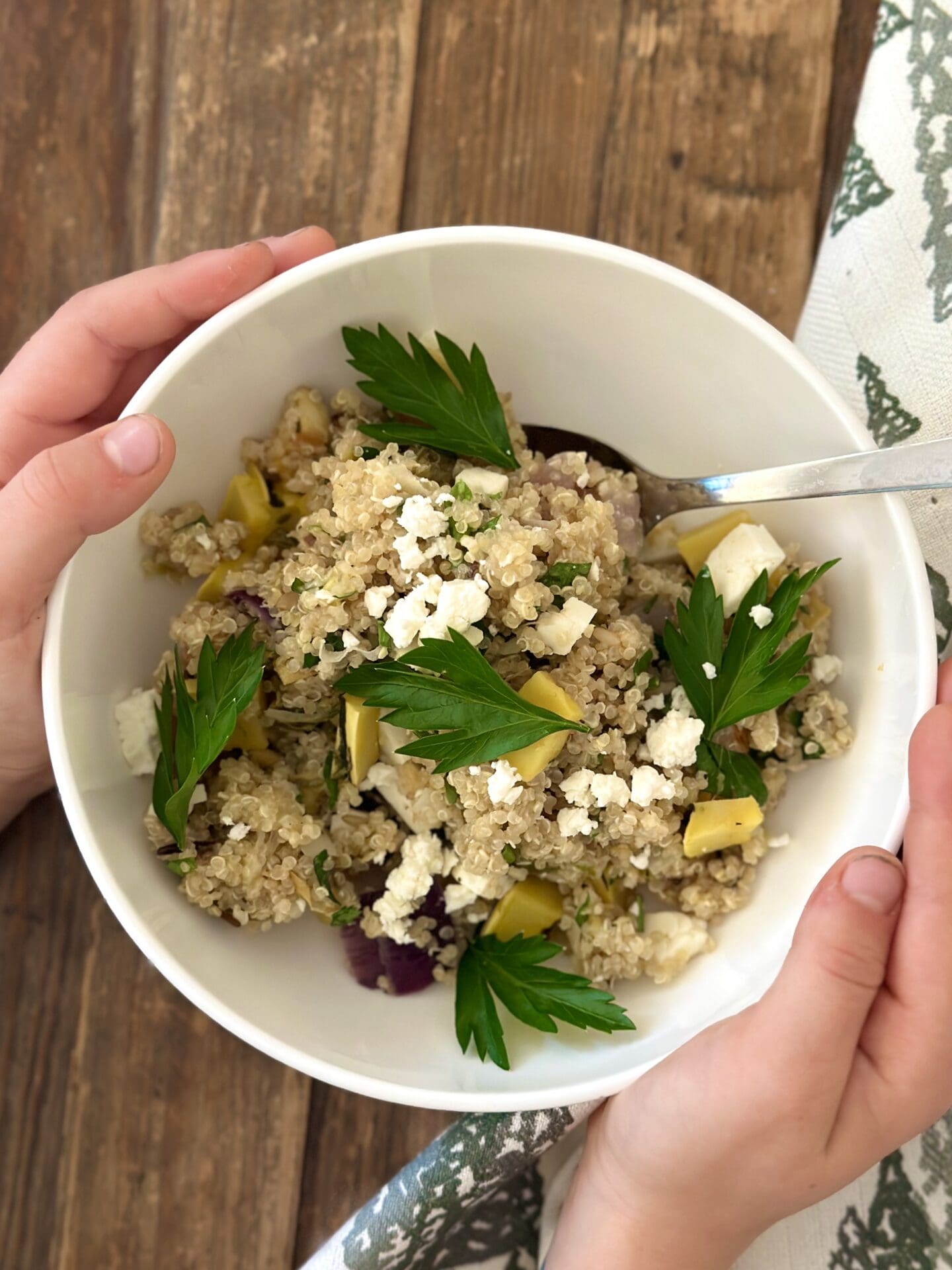 IMG_9493 Little hands hold a bowl of Maple Butter Roasted Vegetables and Pear Quinoa salad made from leftover Thanksgiving vegetables