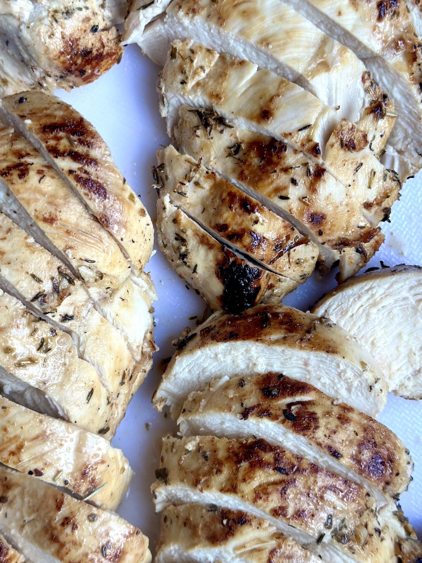 IMG_0435 Grilled marinated chicken is sliced to show that it is perfectly cooked and juicy.