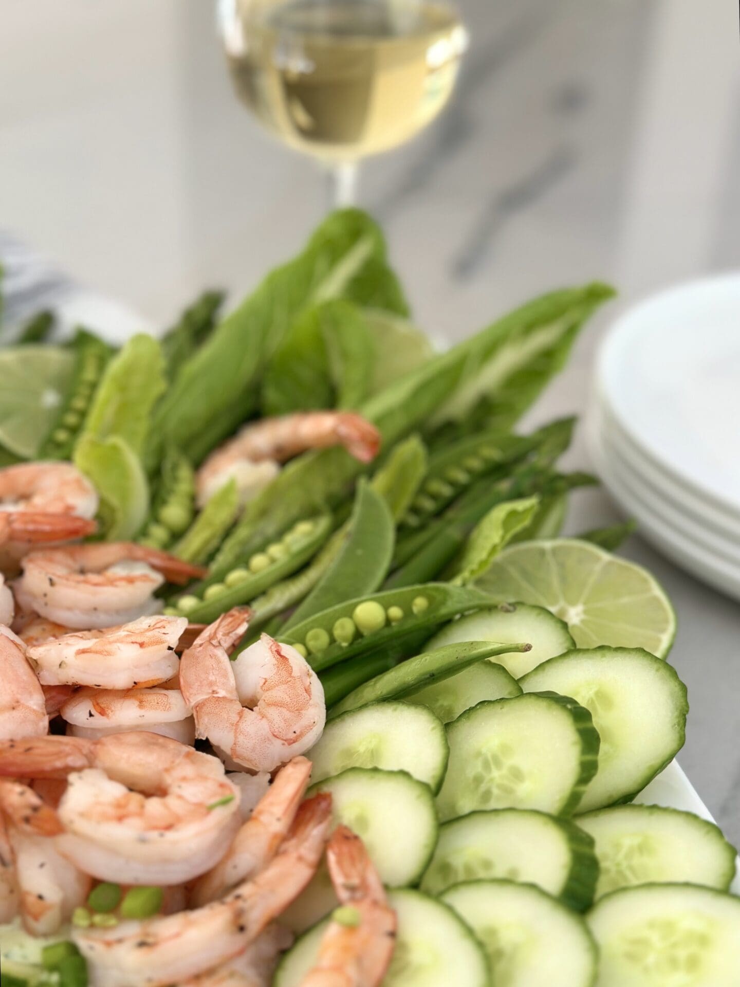 IMG_1438 A platter of roasted shrimp and spring vegetables with creamy herb dip is seen with a chilled glass of white wine