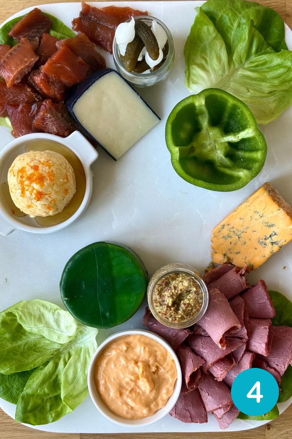 304A460B-E54E-4F1A-BB92-F8AF8A0C6578 Step 4 in building a St Patrick's Day Charcuterie Board. Corned beef and smoked salmon are added to the board.