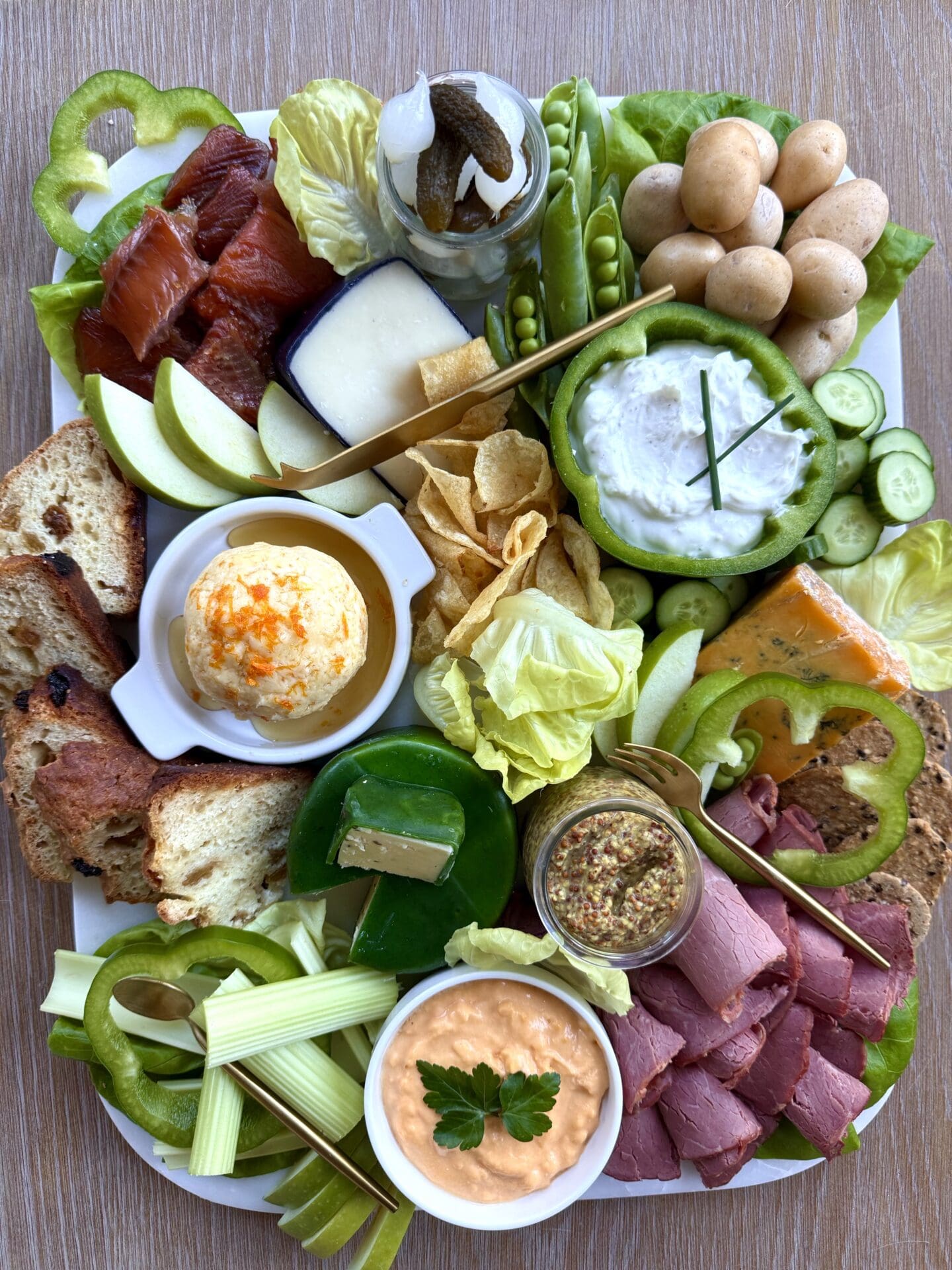 IMG_4850 A lush St Patrick's Day Charcuterie board is seen from above. The board features cheeses, meats, vegetables and fruits in the colours of the Irish flag.