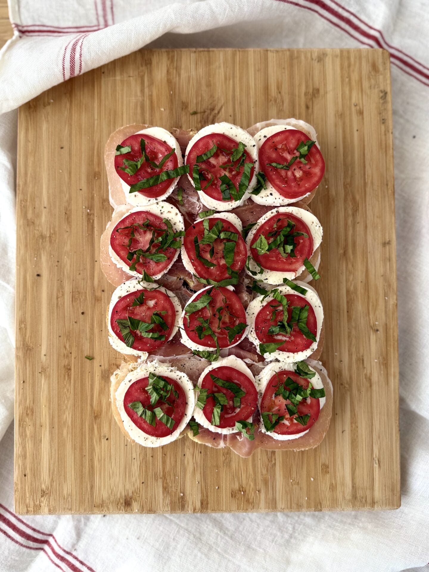 IMG_5017 Fresh chopped basil and freshly ground black pepper are added to Italian Antipasto Sliders in the fifth step