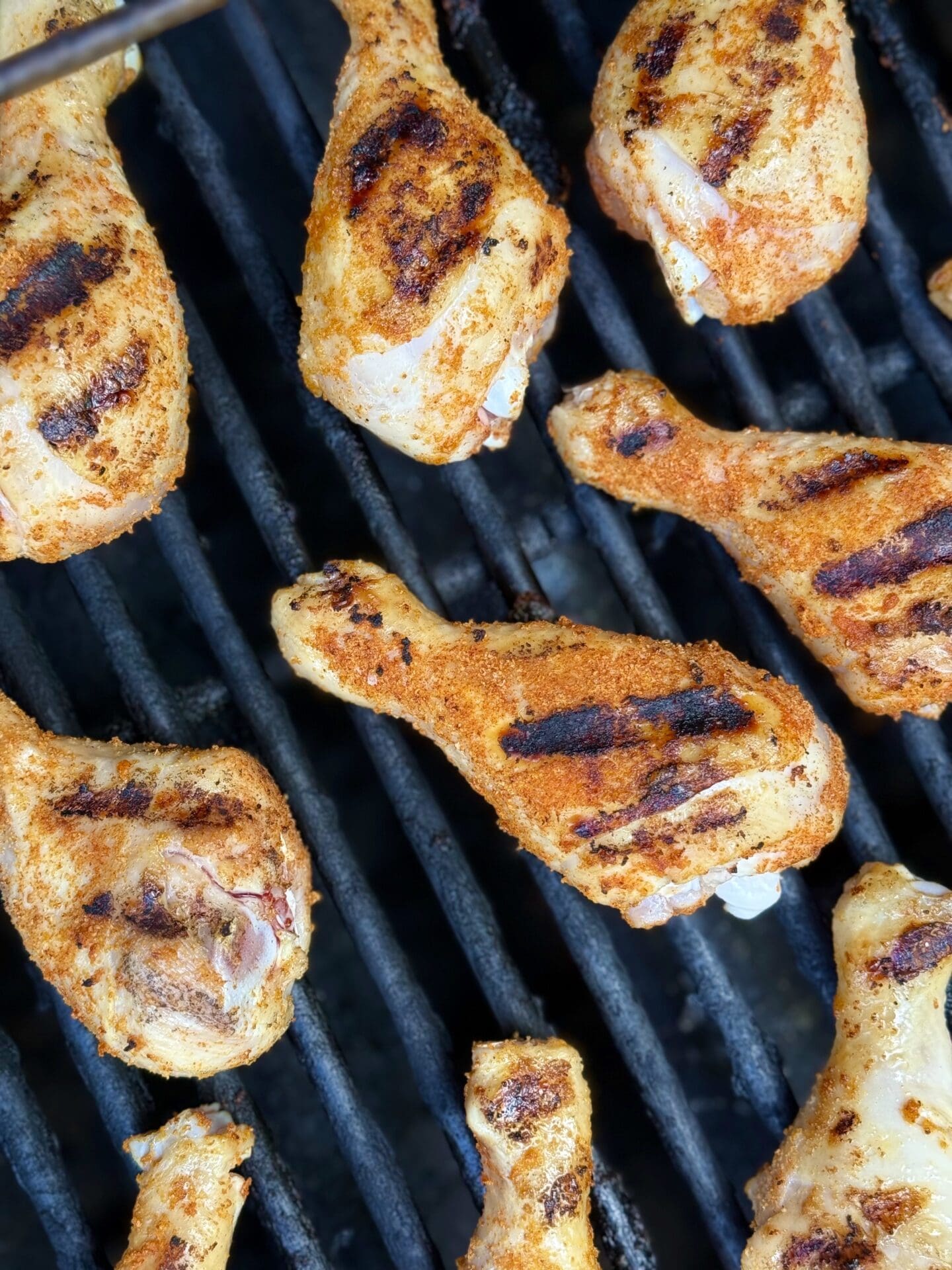 IMG_5918 Chicken Legs with perfect grill marks are seen from above on a hot grill.