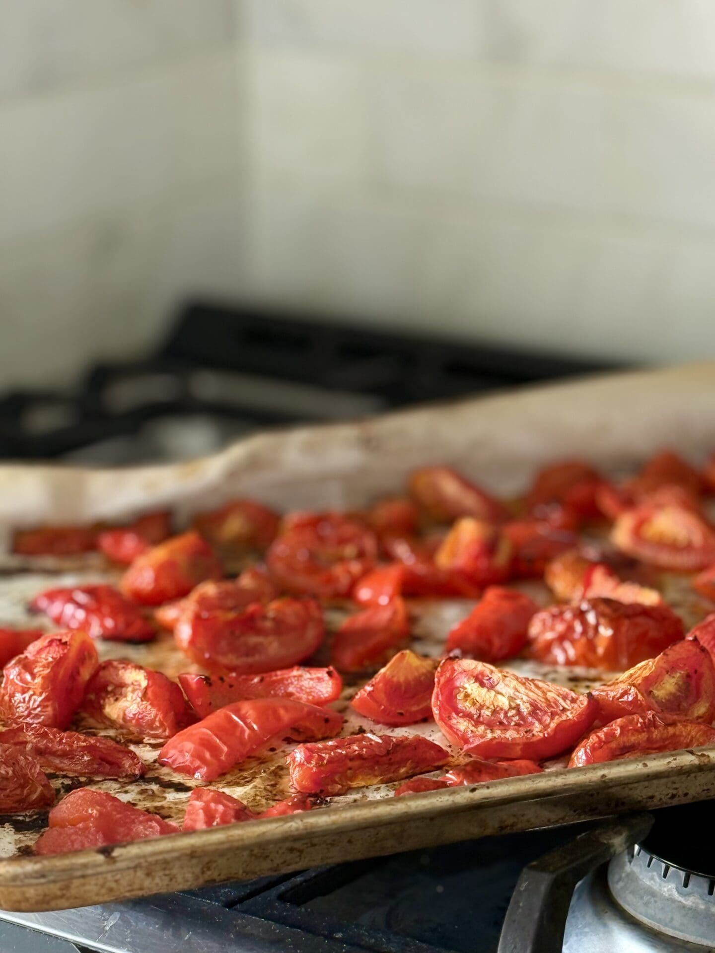 IMG_6806 A baking sheet filled with roasted tomatoes and red peppers cools on a stove top, before being added to Roasted Tomato and Feta Soup.