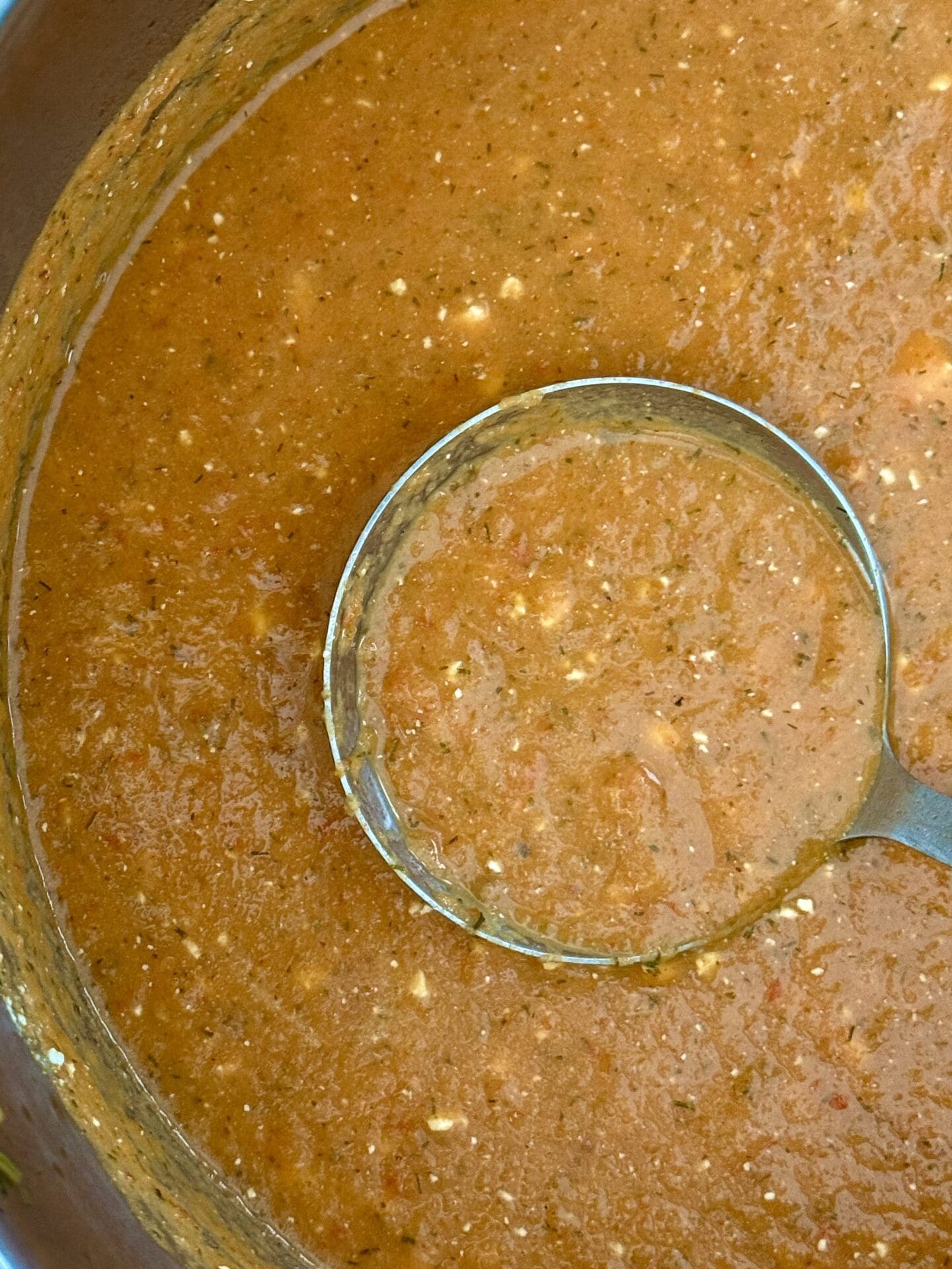 IMG_6818 A ladle rests in a pot of Roasted Tomato and Feta soup, ready to serve.