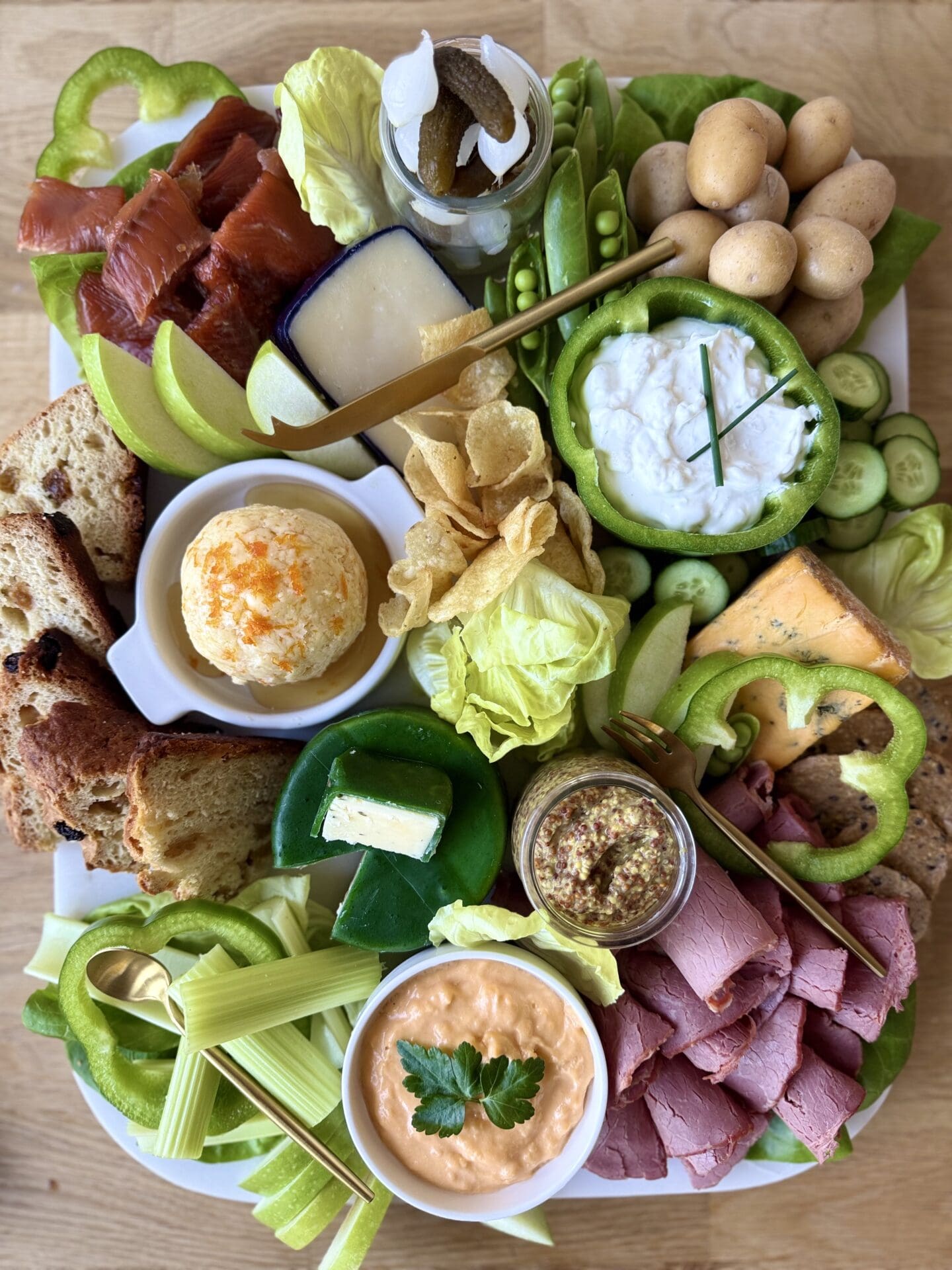 A lavishly filled, St Patrick’s Day themed charcuterie board is seen from above.