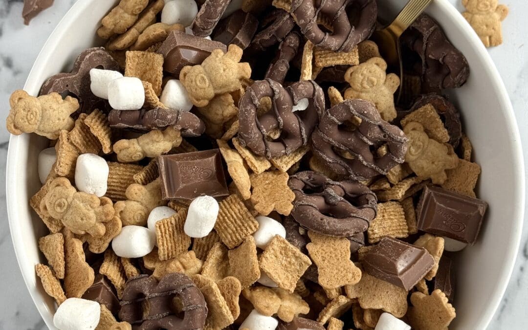 A bowl of S’Mores Snack Mix is seen from above, showing its delicious chocolate, marshmallow and graham cracker flavours as an easy, no-mess, snack mix.