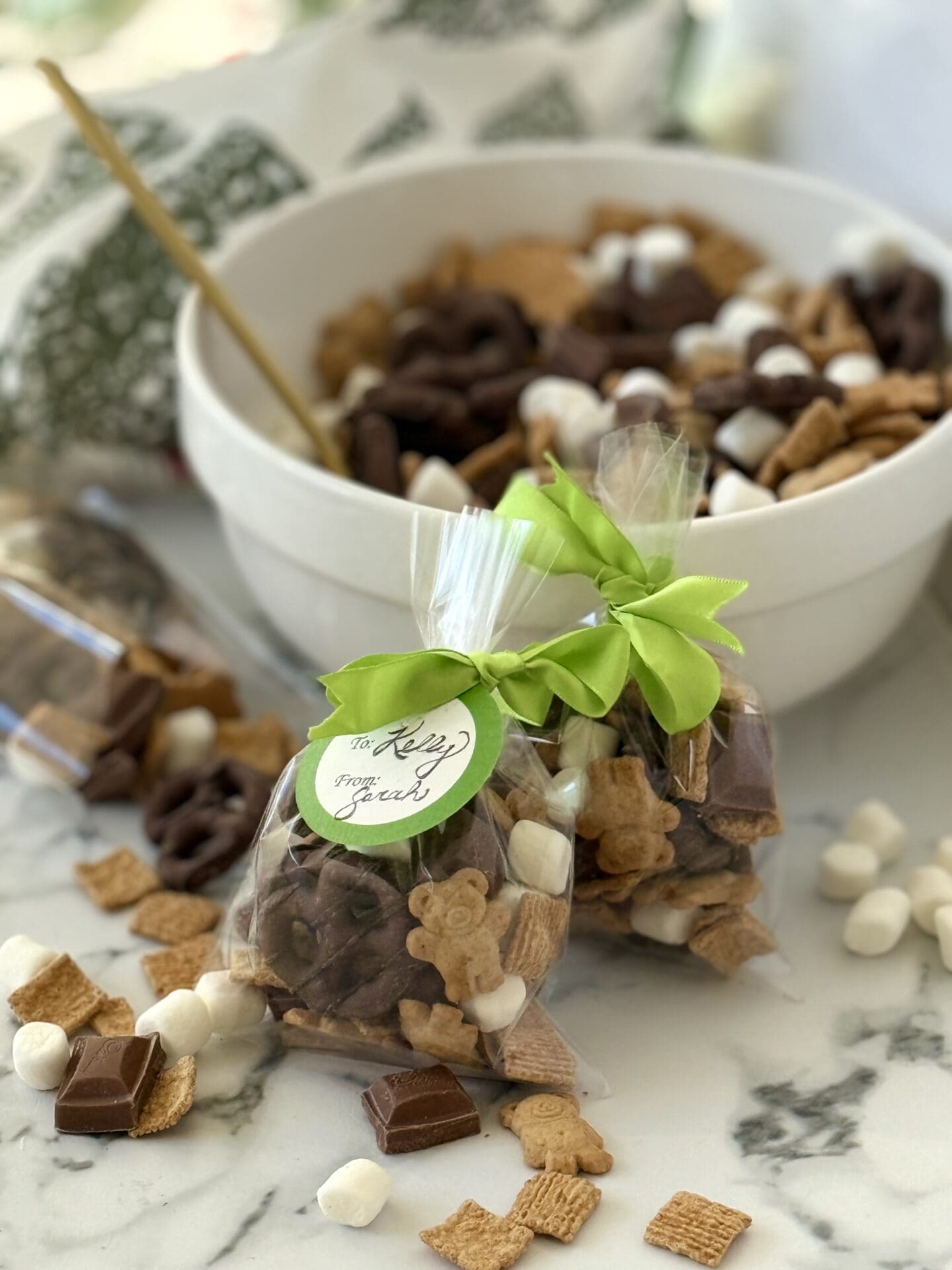 S’Mores Snack Mix is shown packed in cellophane bags and tied with ribbon for easy gifting.