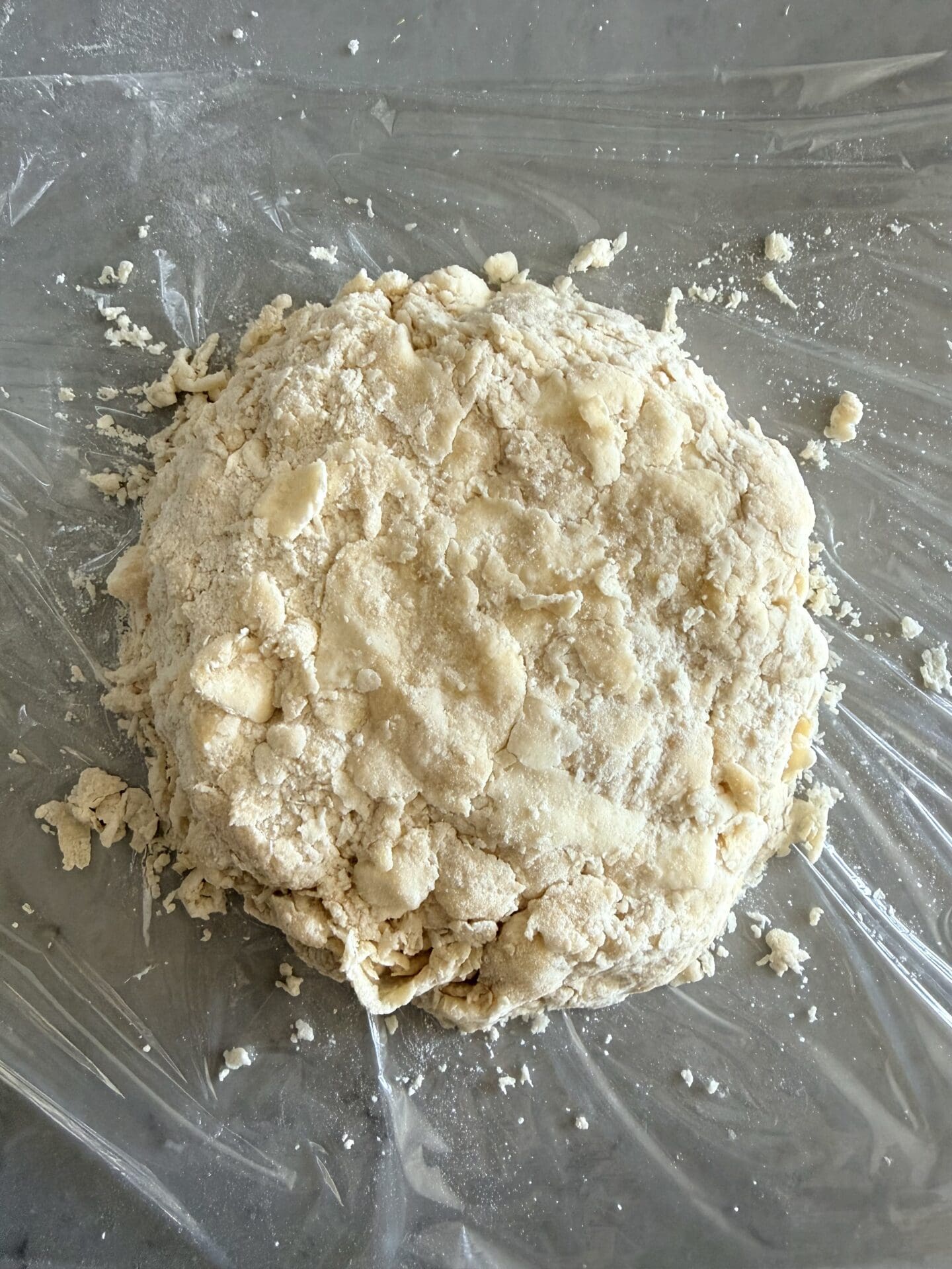 A rough, shaggy pastry dough is seen from above, before resting and chilling.  