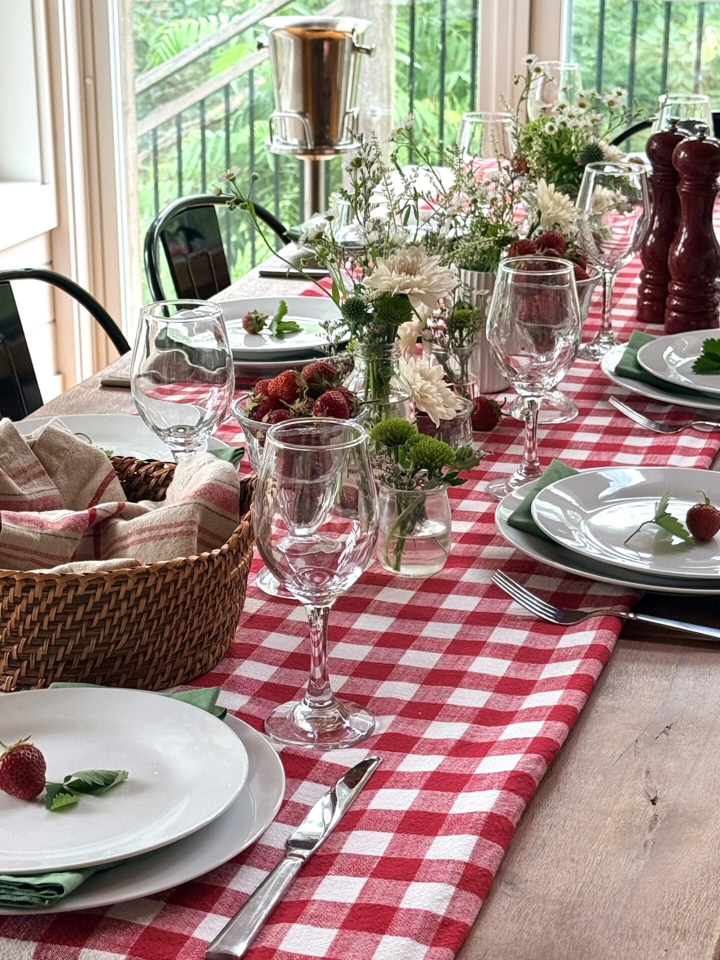 A beautiful table is set for a strawberry themed summer lunch.